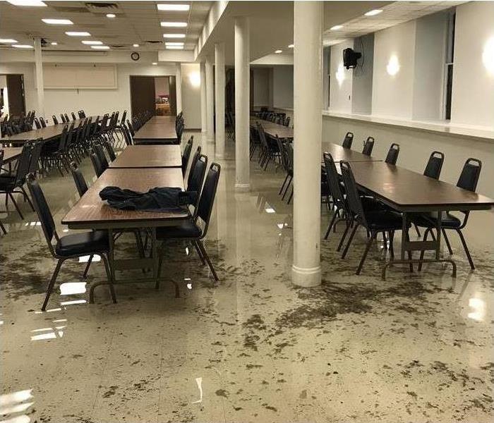 sewage on floor, folding tables and chairs in the cafeteria