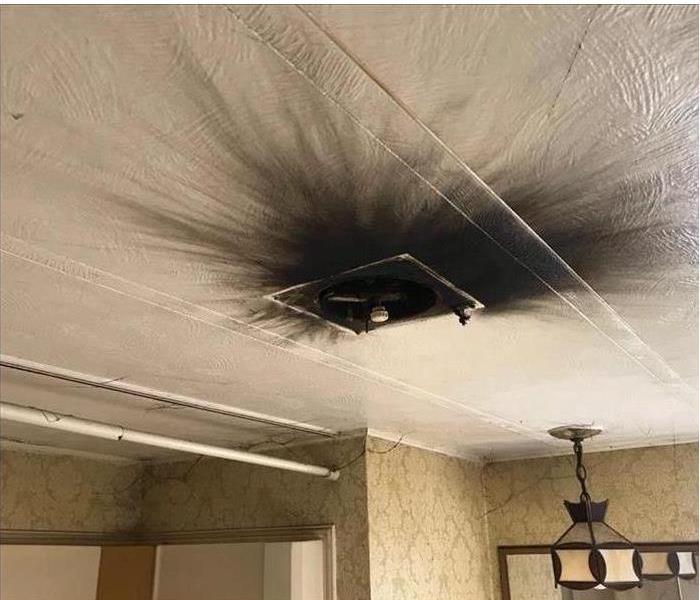 soot at a vent in a ceiling, dirty and black layers