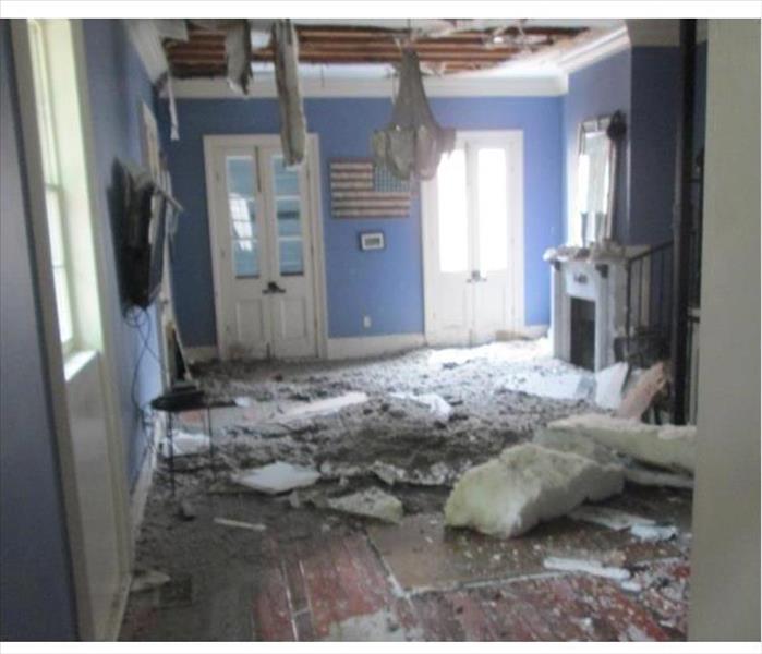 fallen ceiling panels, mess on floor, visible ceiling joists