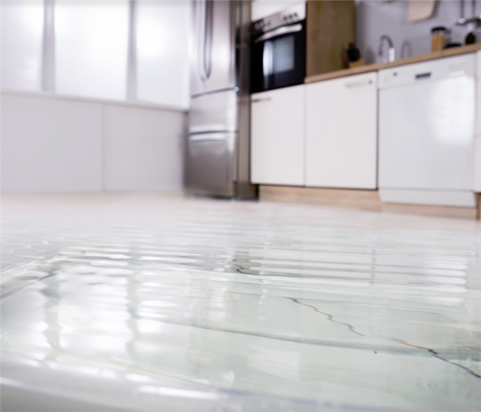 water covering the floor of a kitchen
